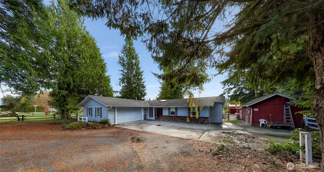 an aerial view of residential houses with outdoor space and swimming pool