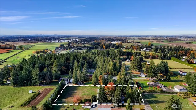 an aerial view of a city with lots of residential buildings ocean and mountain view in back
