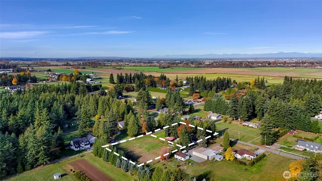 an aerial view of a houses with a yard