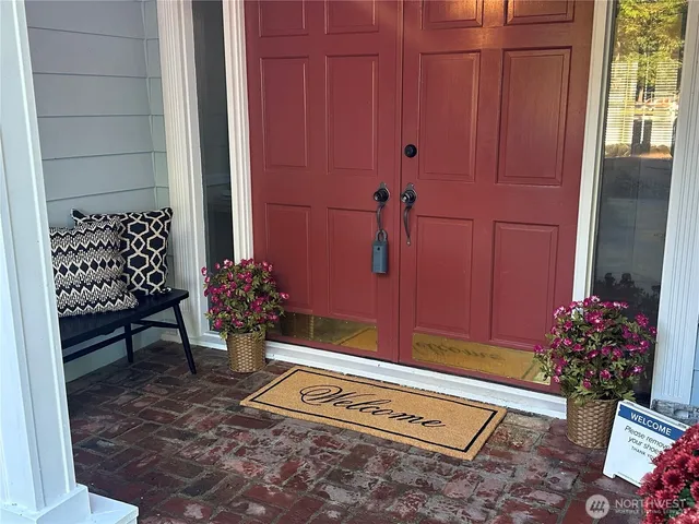 a view of a room with a potted plant and wooden floor