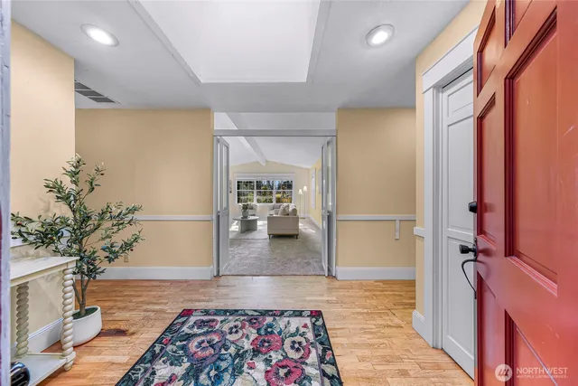 a living room with furniture and large windows