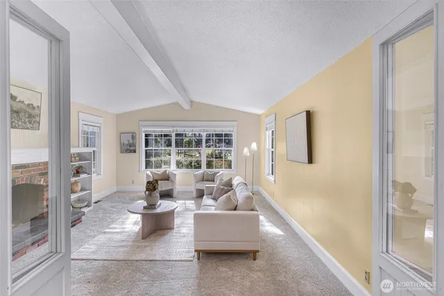 a living room with furniture a window and a fireplace