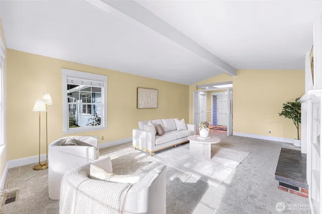 a living room with furniture window and a fireplace