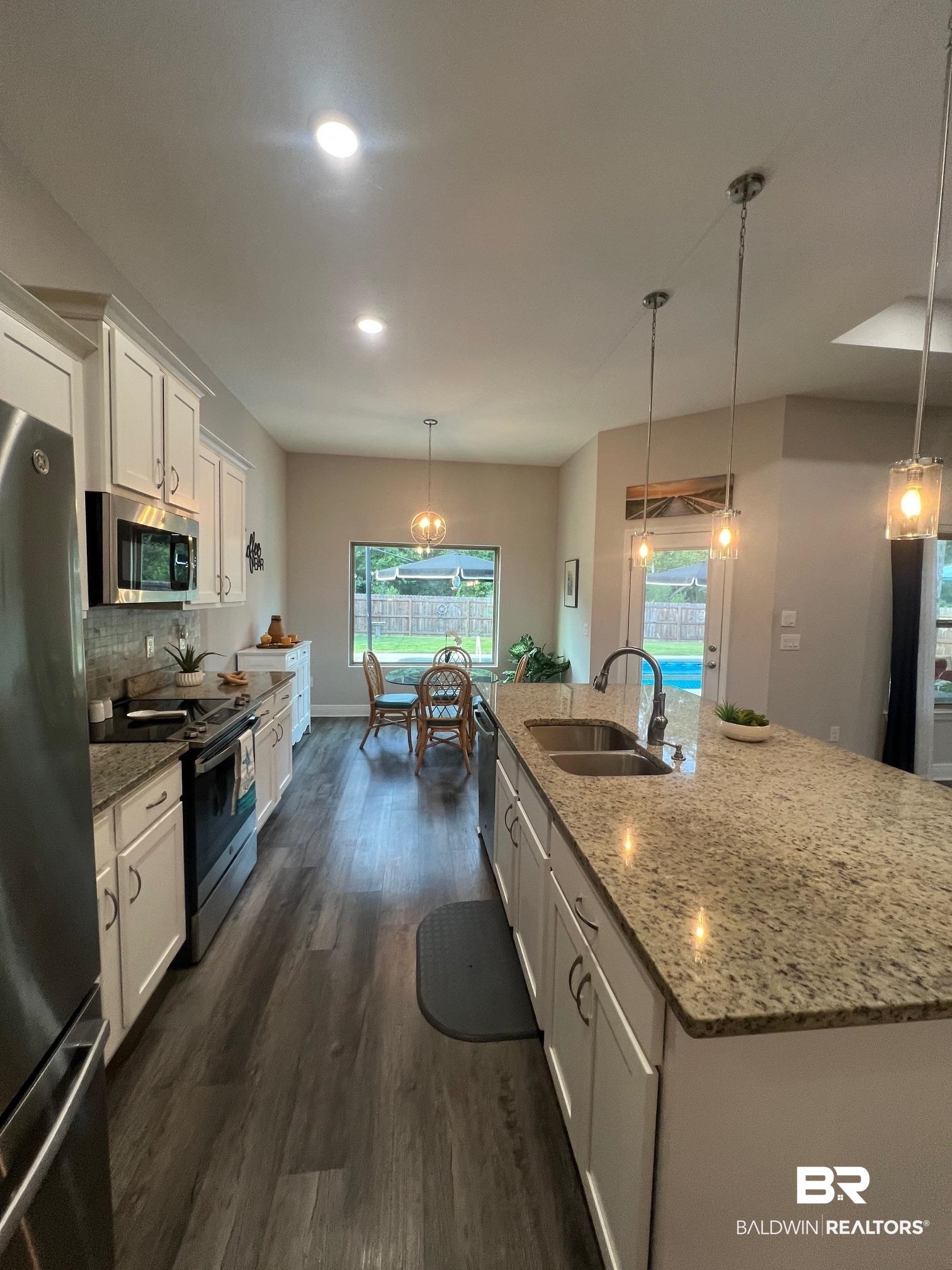 32915 Arbor Ridge Circle Lillian, AL 36549 - Photo 6 of 26 Kitchen featuring stainless steel appliances, white cabinetry, dark wood-style floors, plenty of natural light, and recessed lighting