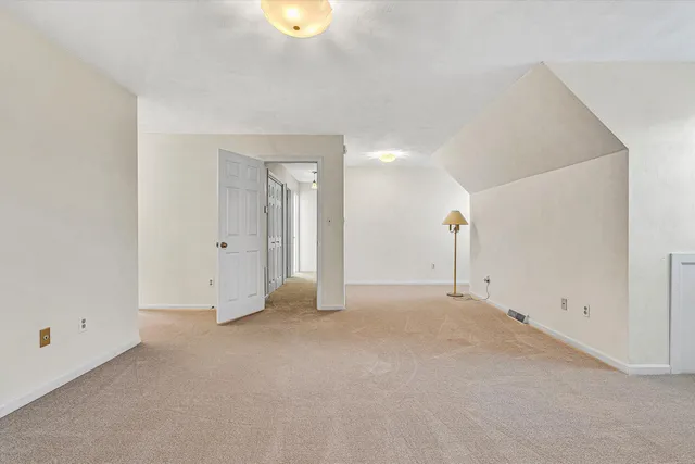 a view of a hallway with wooden shelves