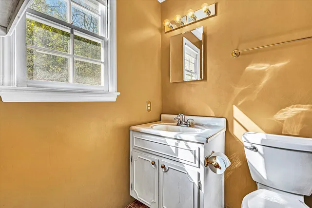 a view of an empty room with window and stairs