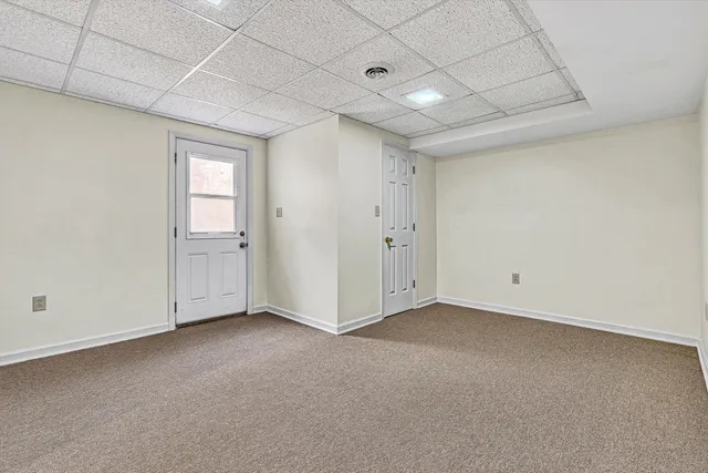 a view of a house with a yard and sitting area