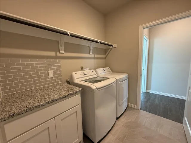 a utility room with washer and dryer