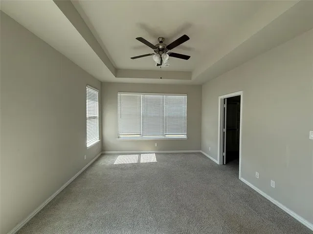 a view of a livingroom with a ceiling fan and window
