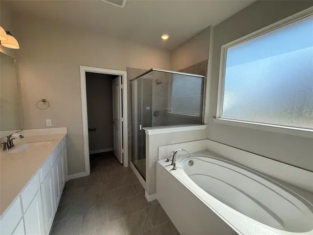 a bathroom with a bathtub and a sink