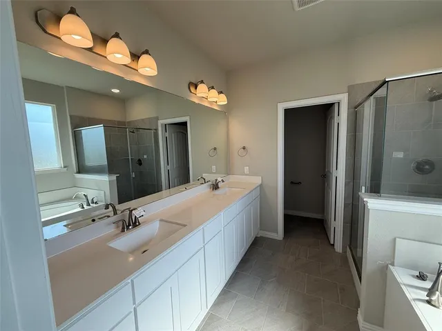 a spacious bathroom with a double vanity sink mirror and toilet