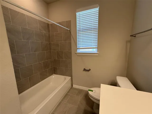 a bathroom with a bathtub and shower