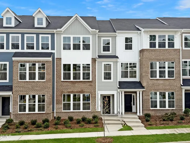 a front view of a residential apartment building with a yard