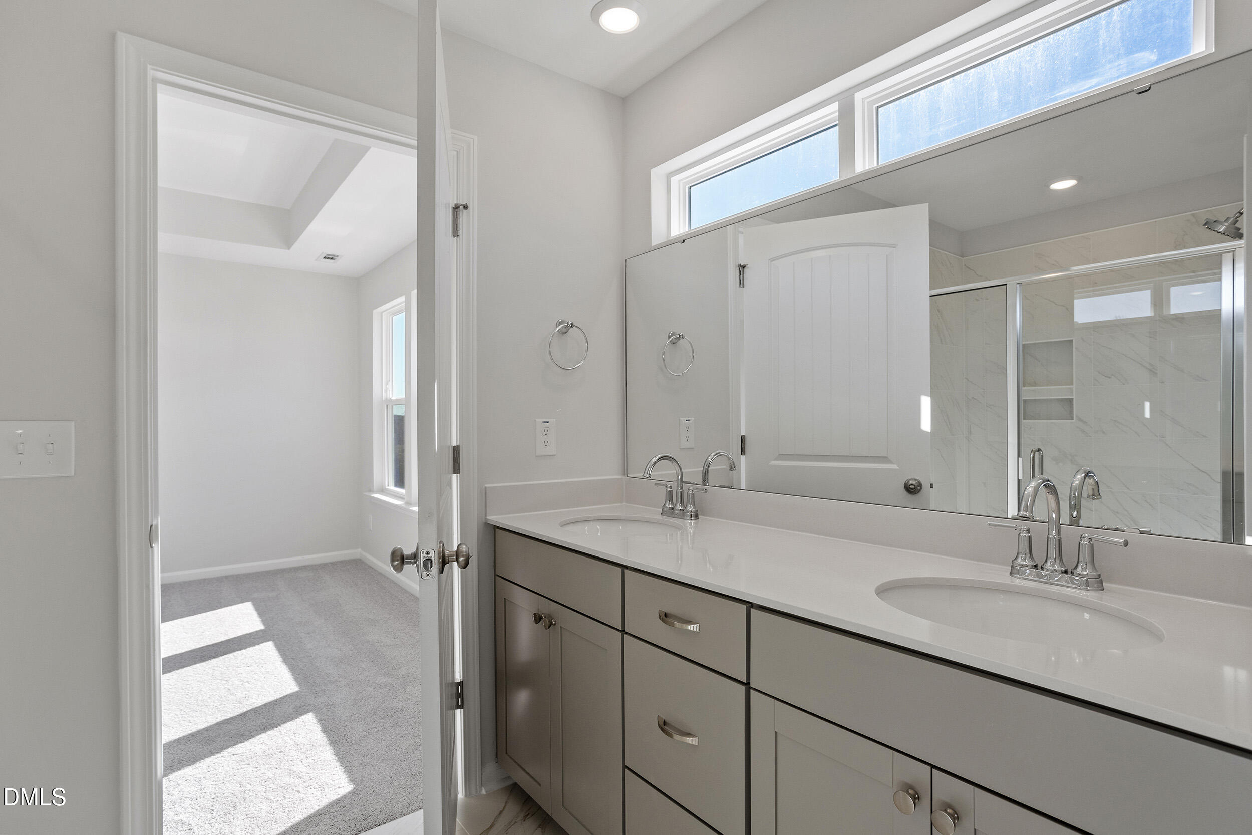 367 Chesapeake Commons Street, Unit 115 Garner, NC 27529 - Photo 14 of 43 a bathroom with a sink double vanity and a mirror