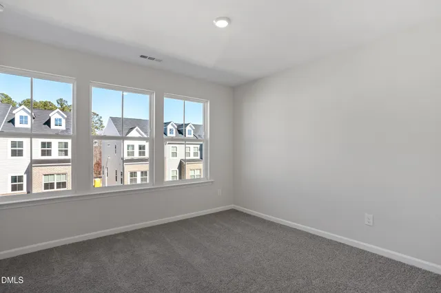 an empty room with a window and a bathroom