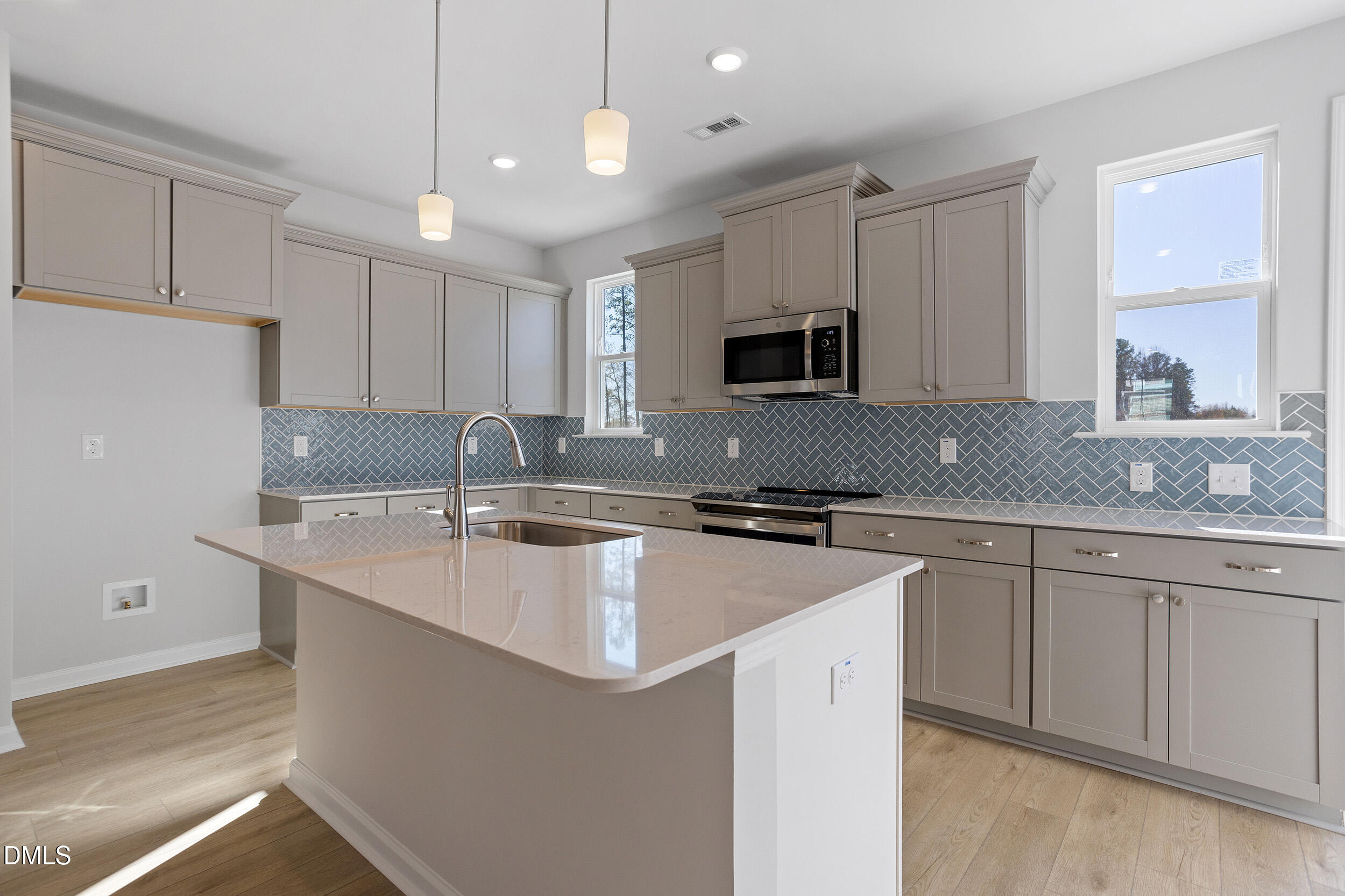 367 Chesapeake Commons Street, Unit 115 Garner, NC 27529 - Photo 4 of 43 a kitchen with stainless steel appliances granite countertop a sink stove and refrigerator