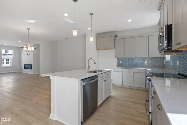 a kitchen with stainless steel appliances granite countertop a sink a stove and a granite counter tops
