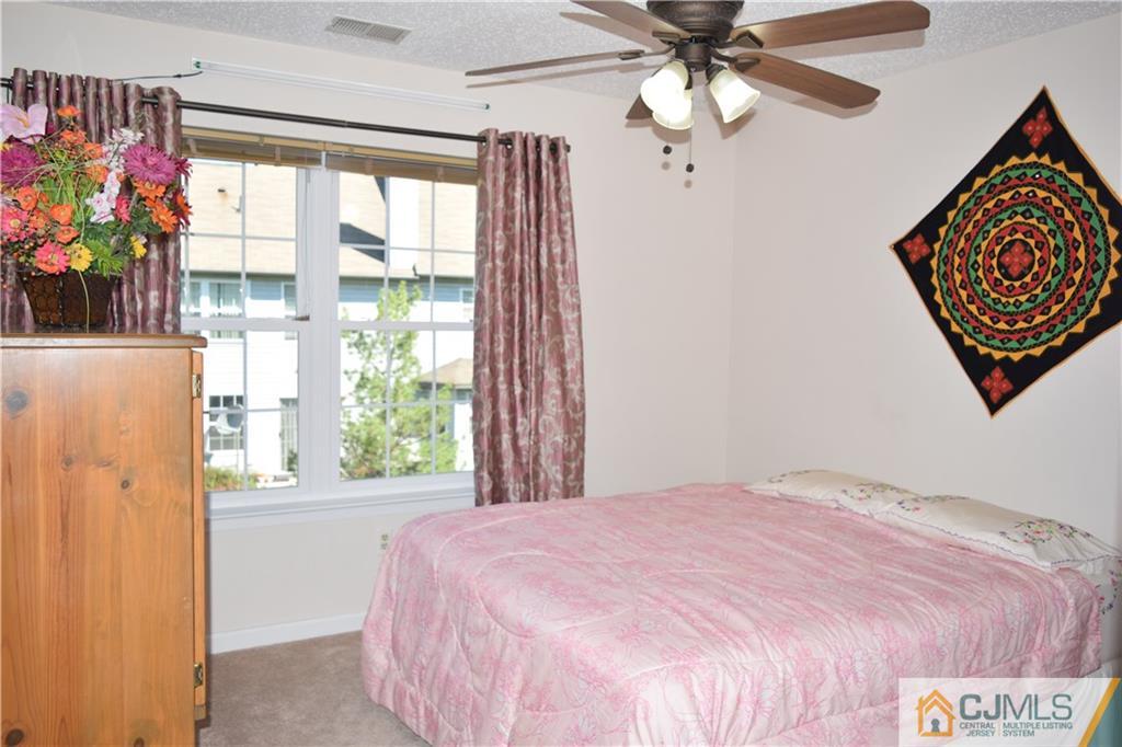 338 Lunar Road Piscataway, NJ 08854 - Photo 11 of 20 a bedroom with a bed dresser and a window