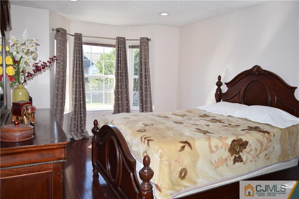 338 Lunar Road Piscataway, NJ 08854 - Photo 12 of 20 a bedroom with a bed and dresser with mirror