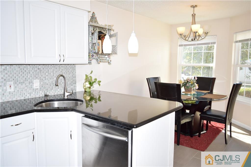 338 Lunar Road Piscataway, NJ 08854 - Photo 3 of 20 a kitchen with a table chairs and a refrigerator