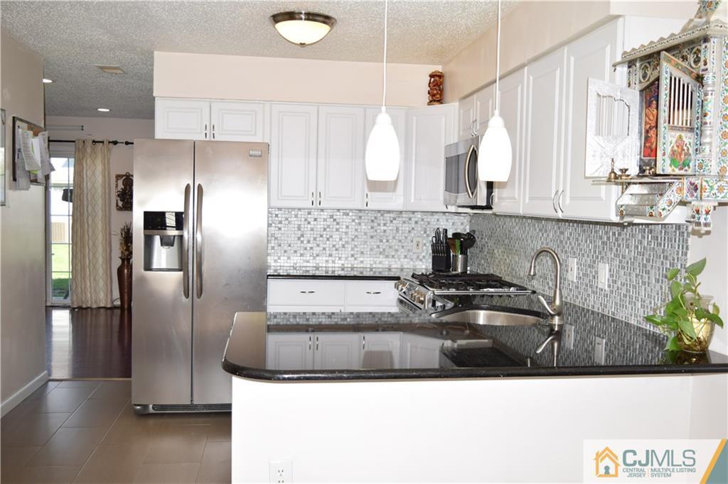 338 Lunar Road Piscataway, NJ 08854 - Photo 4 of 20 a kitchen with stainless steel appliances granite countertop a sink and a refrigerator