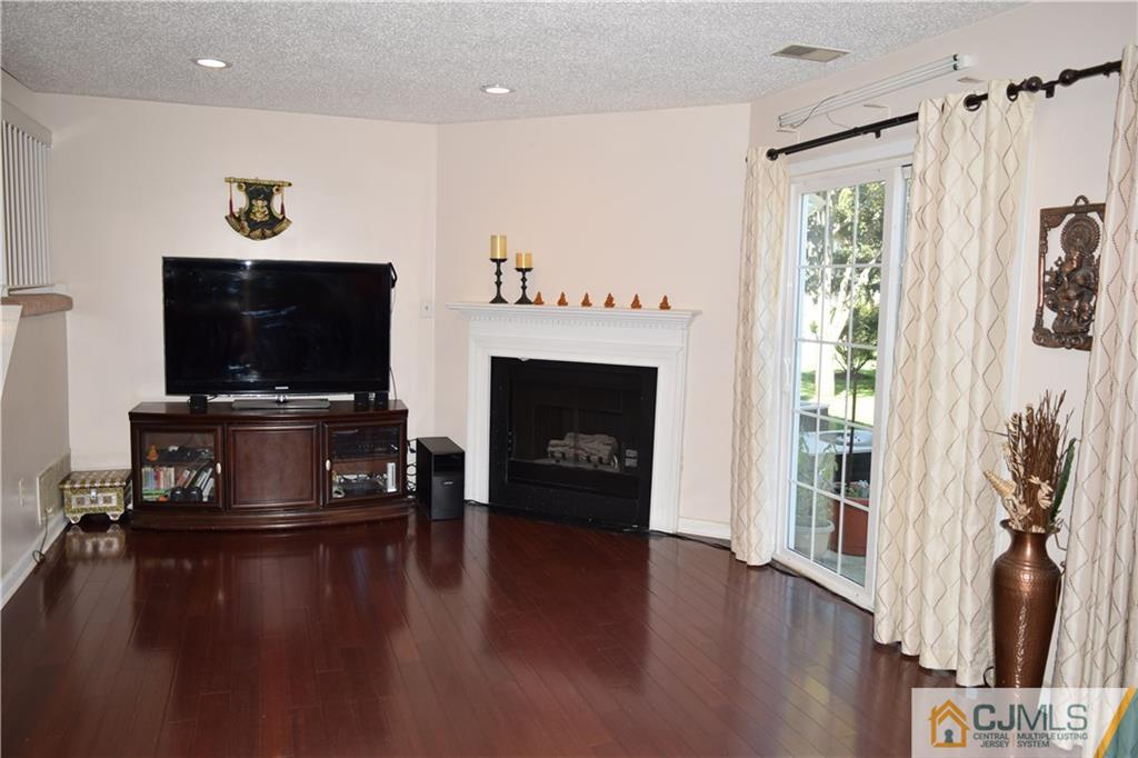 338 Lunar Road Piscataway, NJ 08854 - Photo 7 of 20 a living room with furniture fireplace and flat screen tv