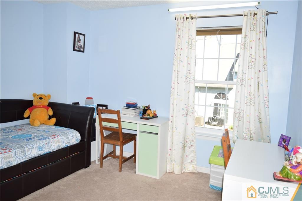 338 Lunar Road Piscataway, NJ 08854 - Photo 10 of 20 a bedroom with a bed and a table