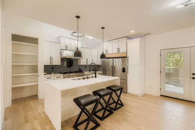 a kitchen that has a cabinets a sink and a stove
