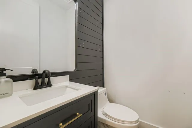 a spacious bedroom with a bed couch and a window