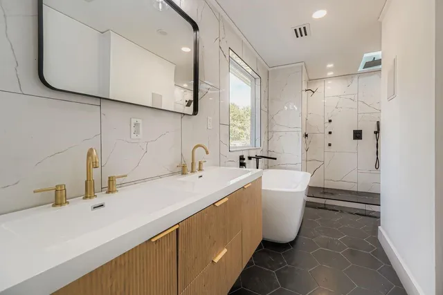 a bathroom with a bathtub and shower