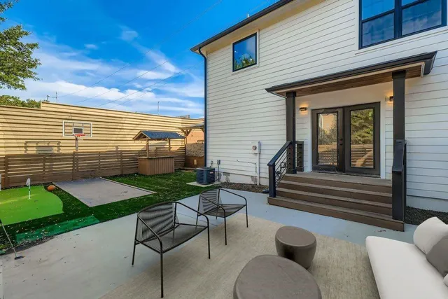 a view of a house with a yard and sitting area