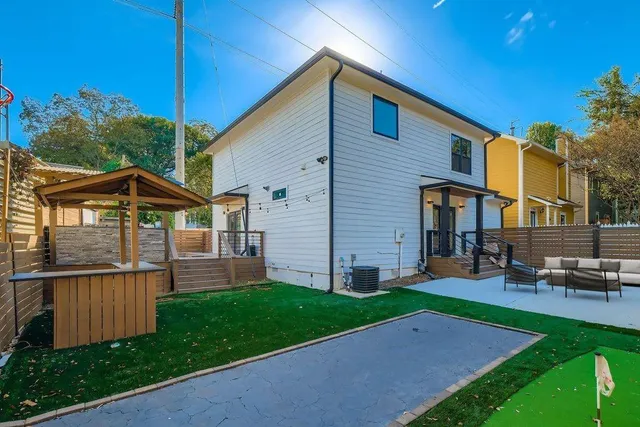 a view of a house with a yard and sitting area