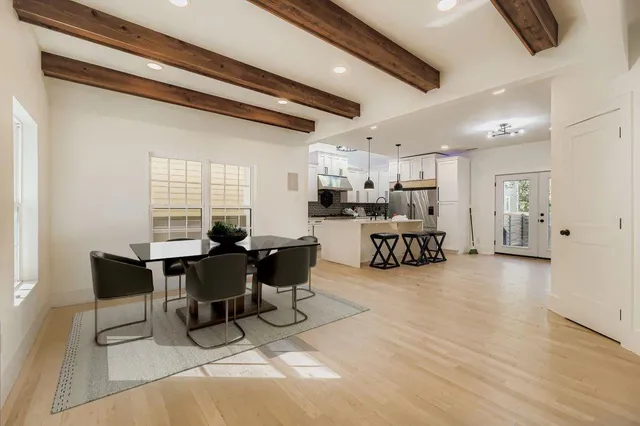 a living room with lots of furniture and kitchen view