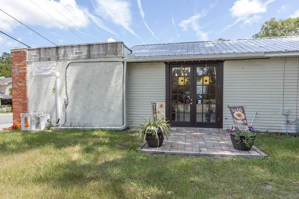 a view of a house with a yard and tree