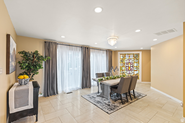 460 Omni Point Road Central Valley, UT 84754 - Photo 31 of 101 Spacious dining area featuring neutral-toned tile flooring, recessed lighting, and a decorative stained-glass window