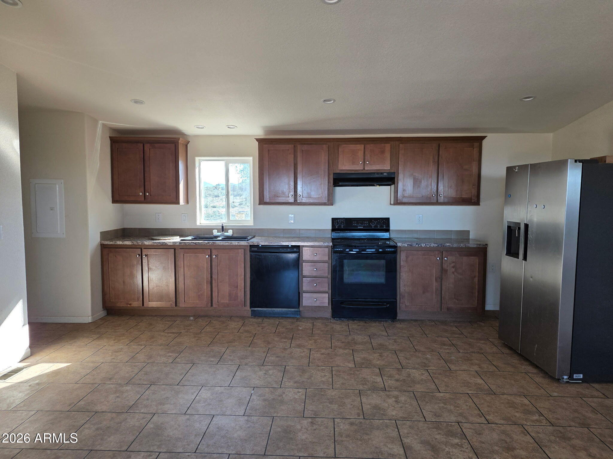 51713 West Fresno Road Maricopa, AZ 85139 - Photo 6 of 9 a large kitchen with granite countertop a stove a sink dishwasher a refrigerator and a microwave oven