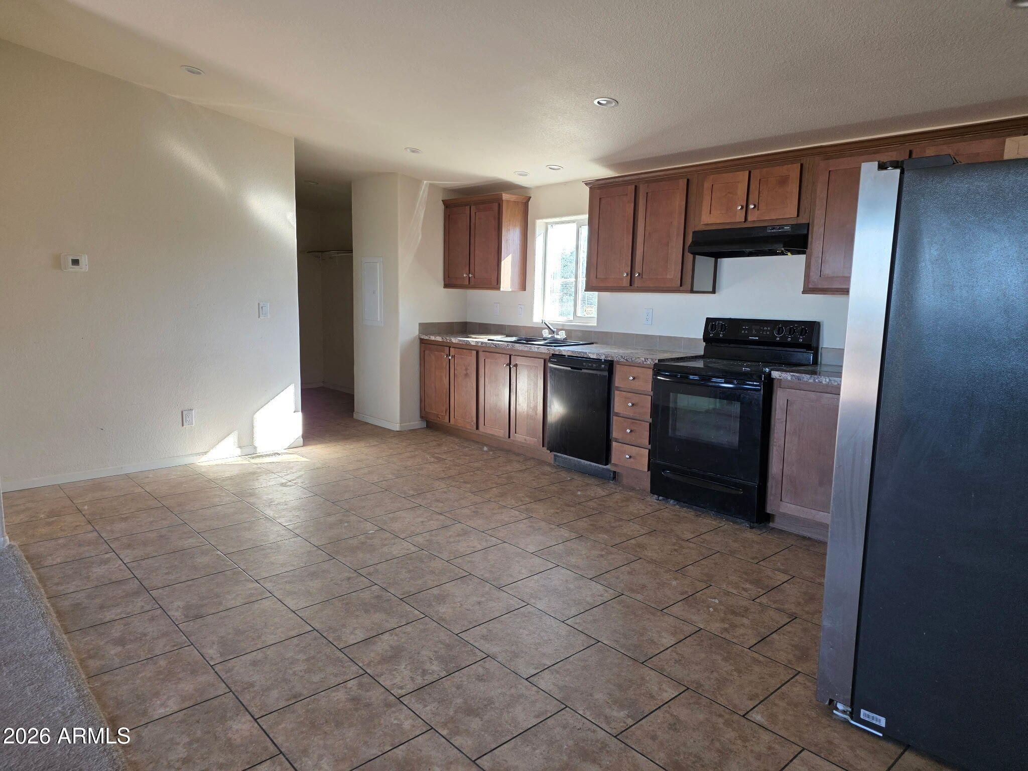 51713 West Fresno Road Maricopa, AZ 85139 - Photo 8 of 9 a kitchen with stainless steel appliances granite countertop a stove a sink and a refrigerator