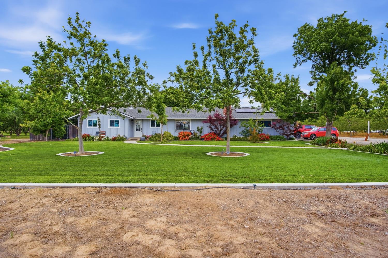 3501 North Avenue Modesto, CA 95358 - Photo 1 of 44 a front view of a house with a garden and trees