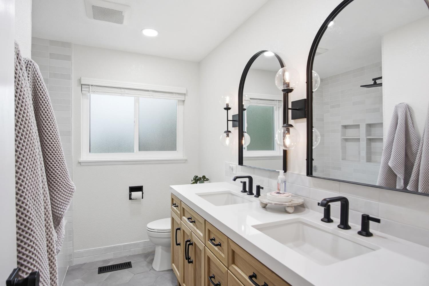 3501 North Avenue Modesto, CA 95358 - Photo 12 of 44 a bathroom with a double vanity sink and a mirror