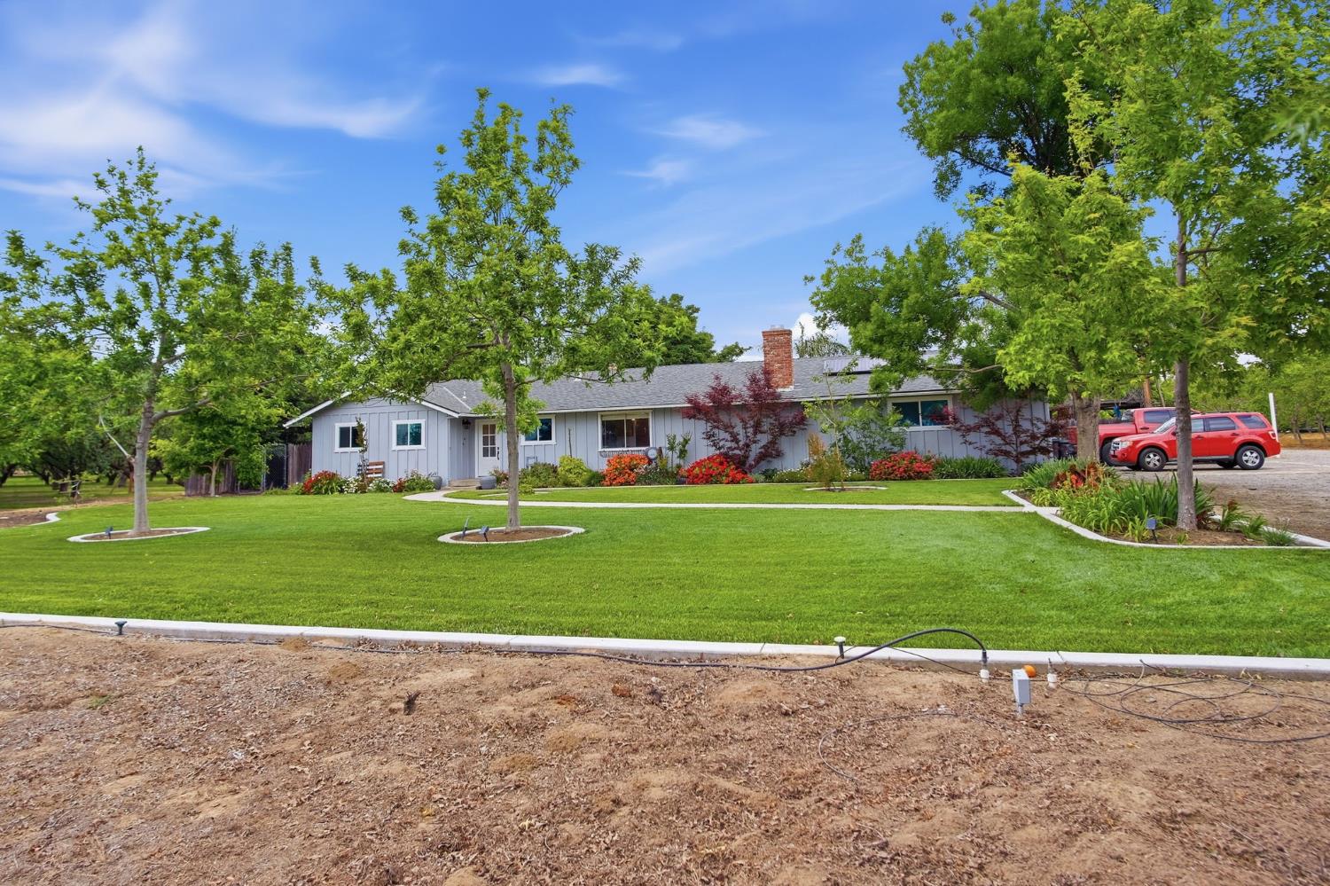 3501 North Avenue Modesto, CA 95358 - Photo 2 of 44 a front view of a house with a yard and garage