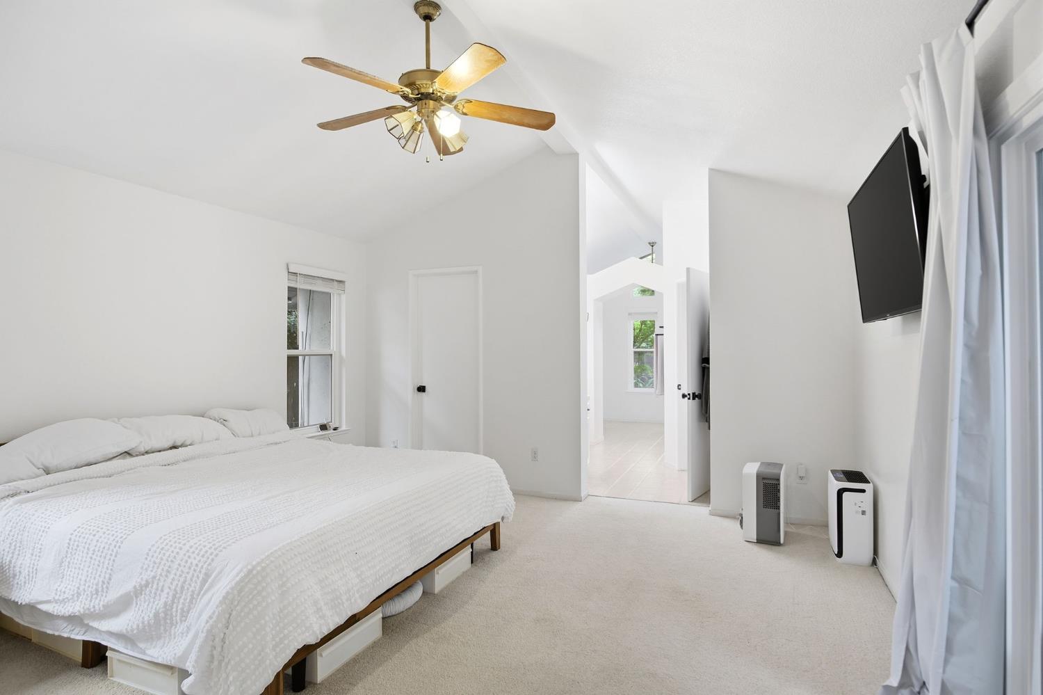 3501 North Avenue Modesto, CA 95358 - Photo 22 of 44 a bedroom with a bed and a chandelier