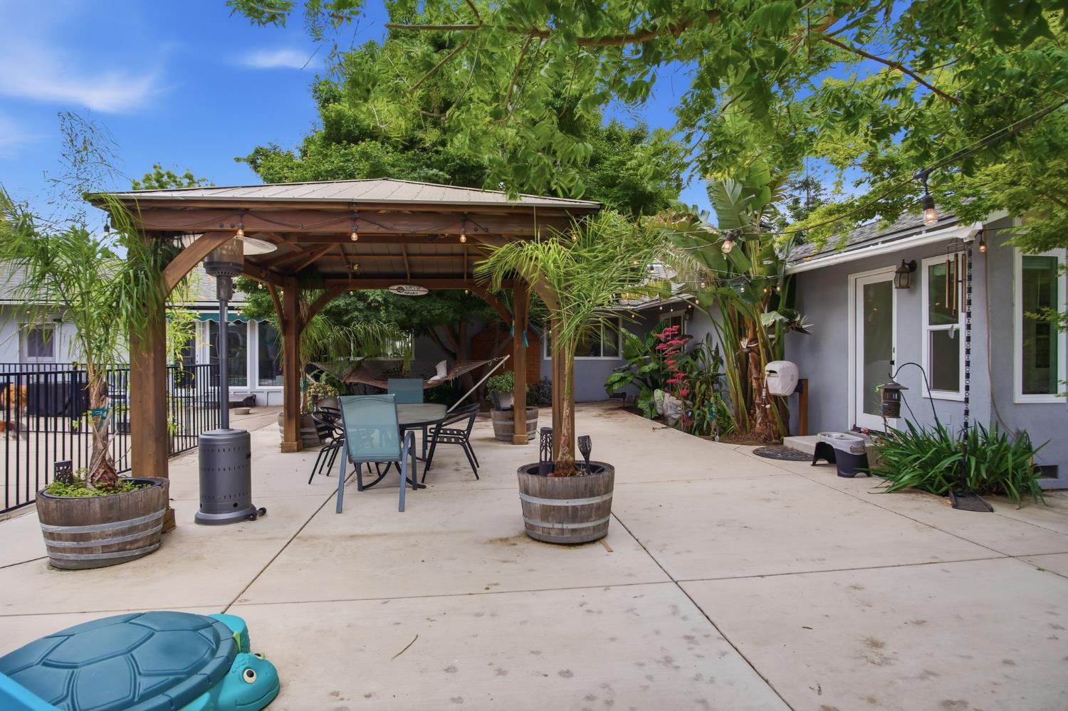 3501 North Avenue Modesto, CA 95358 - Photo 37 of 44 a view of a patio with table and chairs potted plants and floor to ceiling window