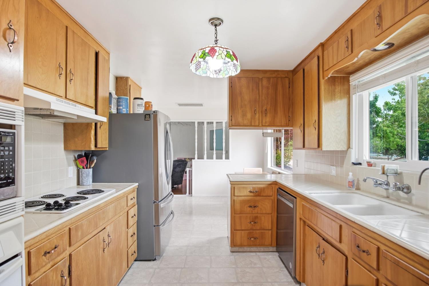 3501 North Avenue Modesto, CA 95358 - Photo 7 of 44 a kitchen with granite countertop a sink stove and refrigerator