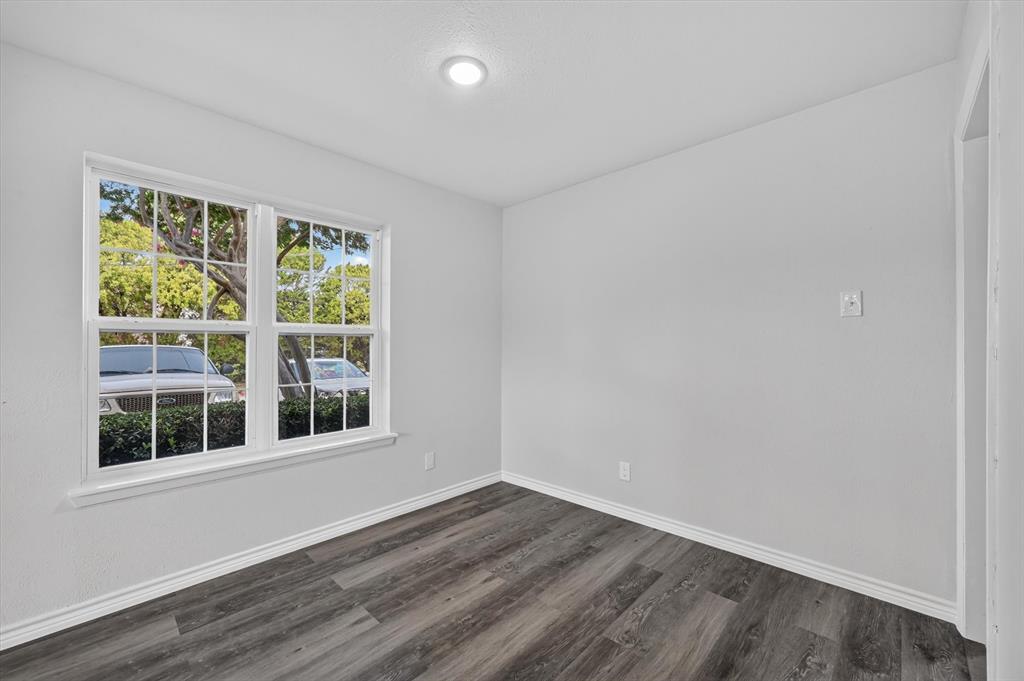 1801 East Grauwyler Road, Unit 101 Irving, TX 75061 - Photo 32 of 39 a view of empty room with wooden floor and fan