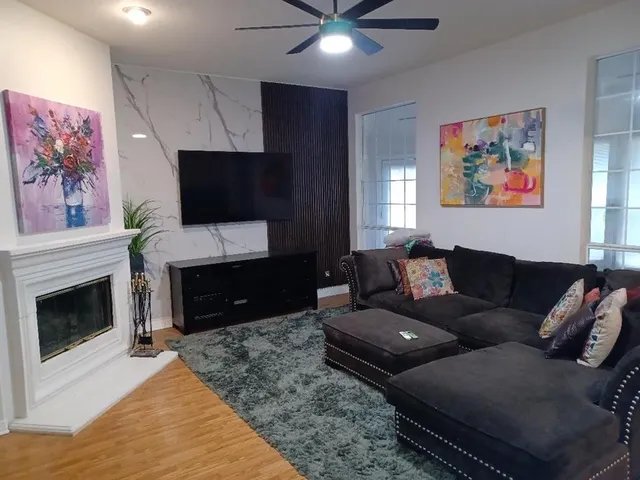 a living room with furniture and a wooden floor