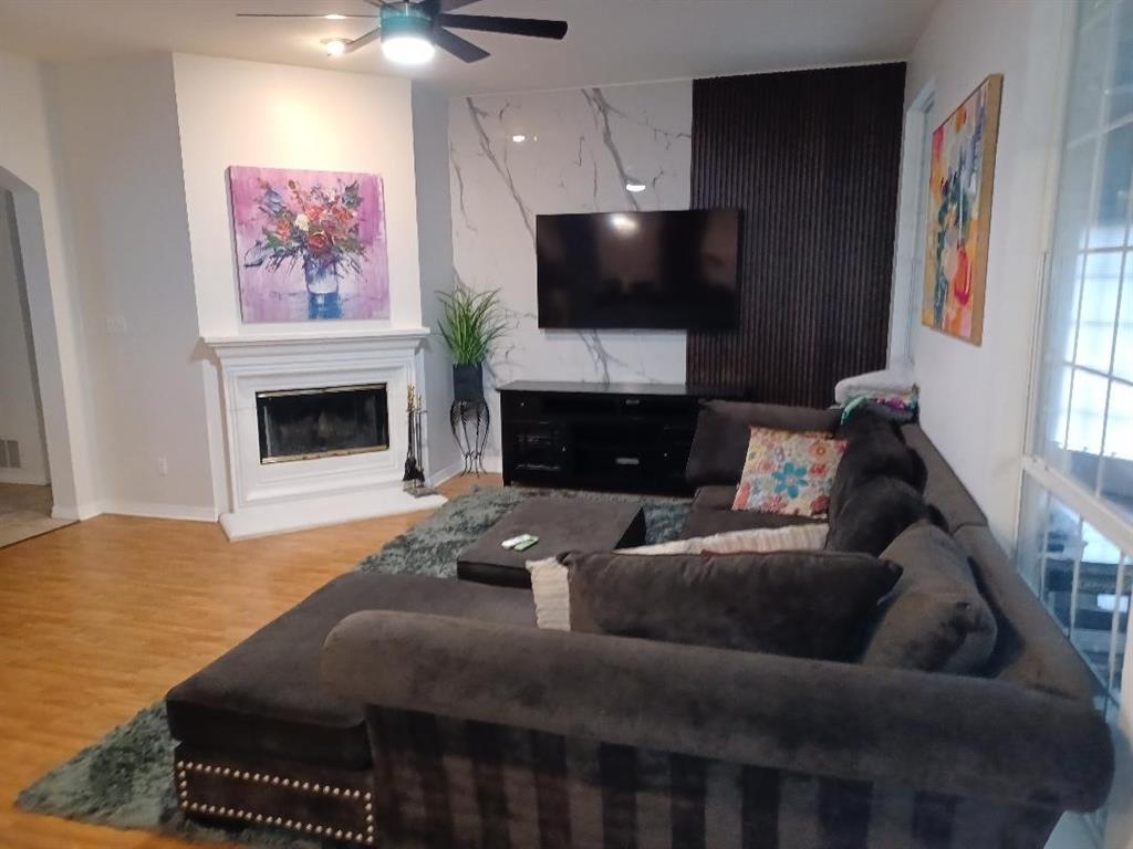 109 Cole Road Red Oak, TX 75154 - Photo 13 of 39 a living room with furniture a flat screen tv and a fireplace