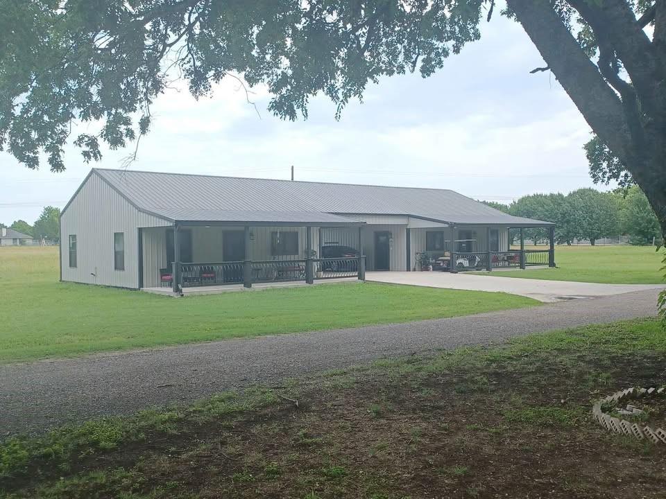 109 Cole Road Red Oak, TX 75154 - Photo 15 of 39 a view of a big house next to a yard with big trees