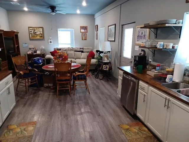 a kitchen with stainless steel appliances granite countertop a sink a stove and a refrigerator