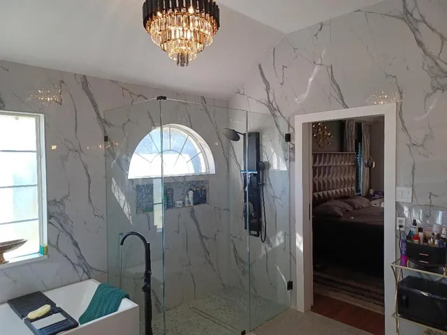 a bathroom with a mirror and a shower