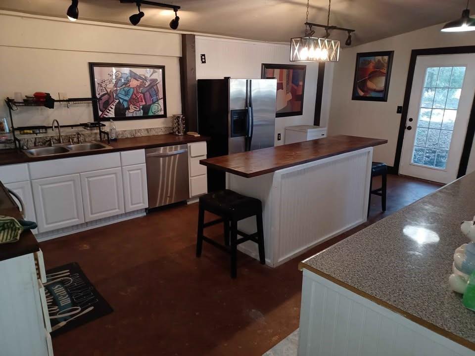 109 Cole Road Red Oak, TX 75154 - Photo 20 of 39 a kitchen with stainless steel appliances granite countertop a sink a stove and a refrigerator